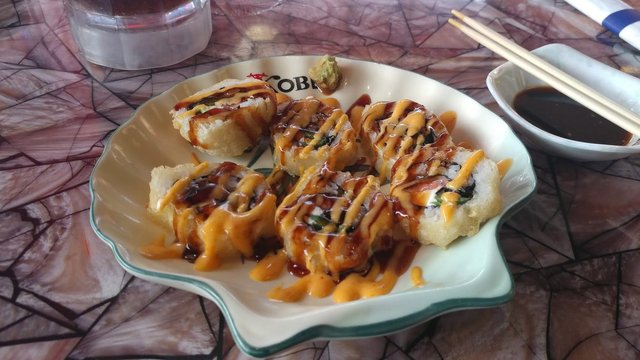 TNT Roll - Tempura fried salmon with jalapeno, topped with eel sauce & spicy mayo.