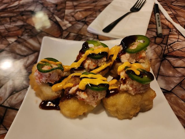 Hurricane Roll - Tempura Fried Spicy Tuna with Cream Cheese & Avocado , topped with Crab Mix, Jalapeno, Eel Sauce & Spicy Mayo.