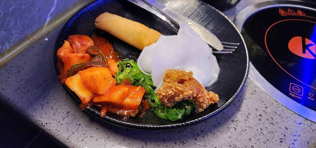 Daikon Radish, Seaweed Salad, Kimchi, Spring Roll, Popcorn Chicken
