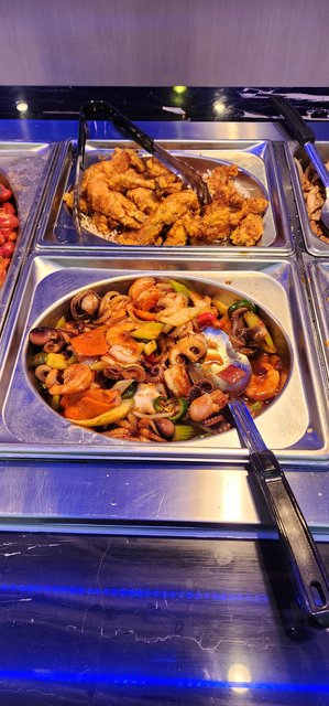 Some type of Boiled Seafood with Jalapeno, squid, carrots,celery, shrimp, red pepper.